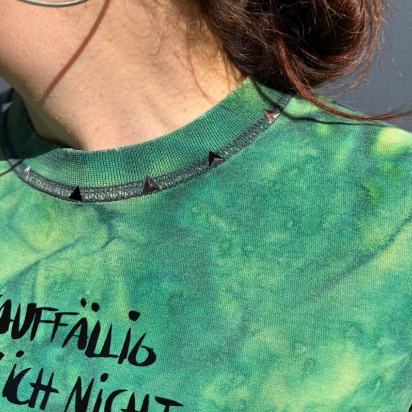 Alextravagant_T-Shirt-unauffaellig-kann-ich-nicht_limette-dunkelgruen-(M)_7 Upcycling T-Shirt aus Second Hand Merchandise mit Motiv "Unauffällig kann ich nicht" von Grafikerin Charleen Dröse (Rocketpennie)